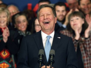 Republican presidential candidate Ohio Gov. John Kasich laughs as he speaks to supporters Tuesday, Feb. 9, 2016, in Concord, N.H., at his primary night rally, (AP Photo/Jim Cole)